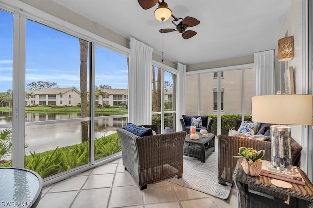 sunroom / solarium with a water view and ceiling fan