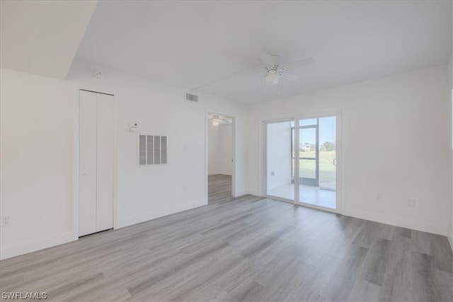 empty room featuring light wood-type flooring and ceiling fan