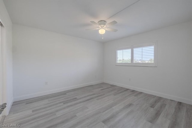 empty room with ceiling fan and light wood-type flooring