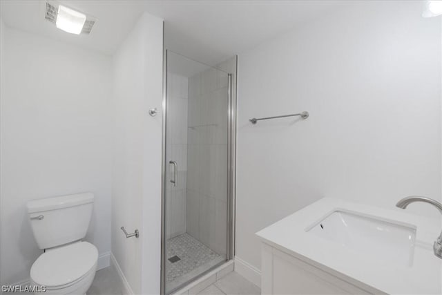 bathroom with tile patterned floors, vanity, toilet, and an enclosed shower