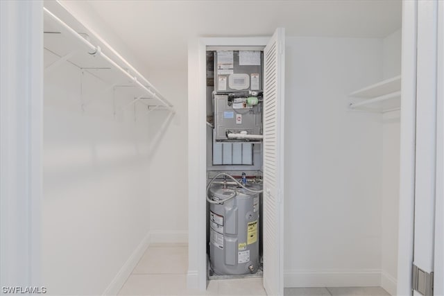 interior space featuring light tile patterned floors and water heater