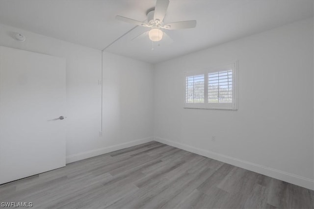 empty room featuring light wood-type flooring and ceiling fan