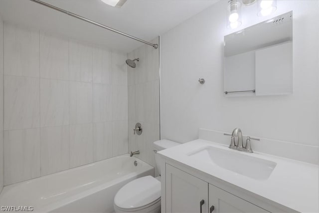 full bathroom featuring vanity, toilet, and tiled shower / bath