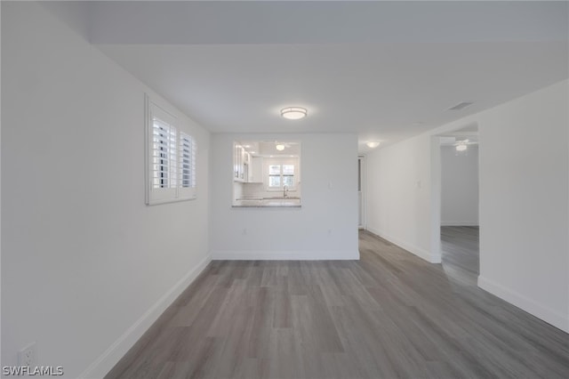 spare room with hardwood / wood-style flooring and ceiling fan