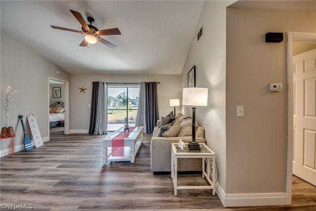 living room featuring ceiling fan and hardwood / wood-style flooring