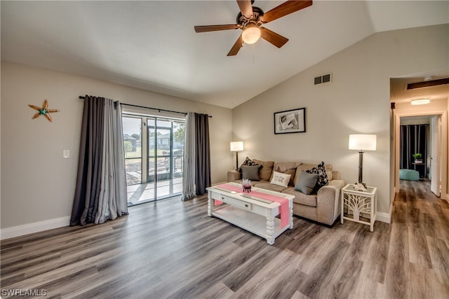 living room featuring hardwood / wood-style floors, ceiling fan, and vaulted ceiling