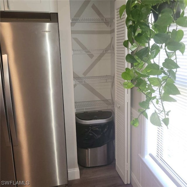 interior details featuring stainless steel refrigerator and dark hardwood / wood-style floors