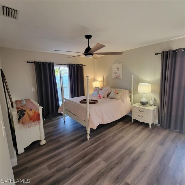 bedroom with ceiling fan and dark wood-type flooring