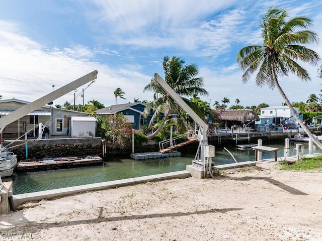 view of playground with a dock and a water view