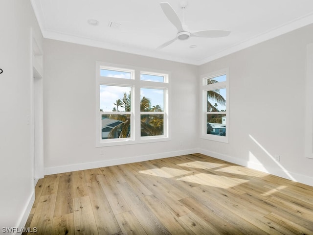 empty room featuring crown molding, light hardwood / wood-style floors, and ceiling fan