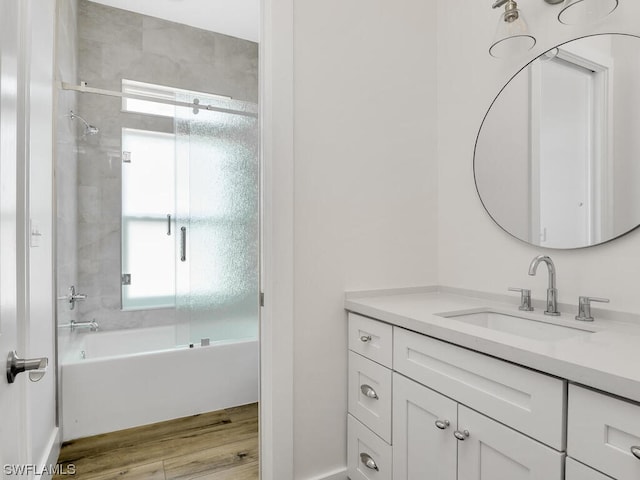 bathroom with vanity, plenty of natural light, shower / tub combination, and wood-type flooring