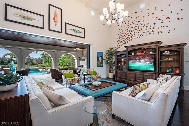 living room with a notable chandelier, dark wood-type flooring, and high vaulted ceiling