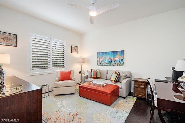 living room with ceiling fan and dark hardwood / wood-style flooring