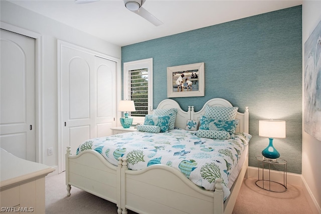 bedroom with a closet, ceiling fan, and carpet floors