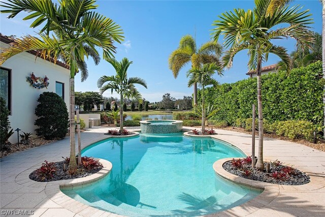 view of swimming pool with a patio and an in ground hot tub