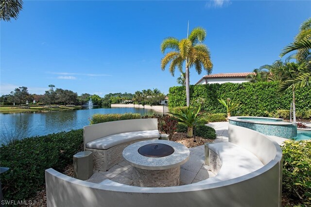 view of patio featuring a water view and a fire pit