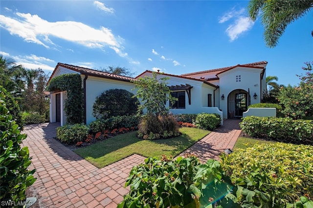 mediterranean / spanish-style house with a front lawn