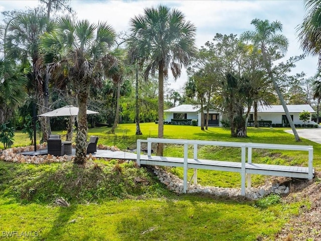 view of property's community featuring an outdoor hangout area and a yard