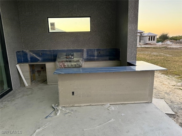 view of patio terrace at dusk