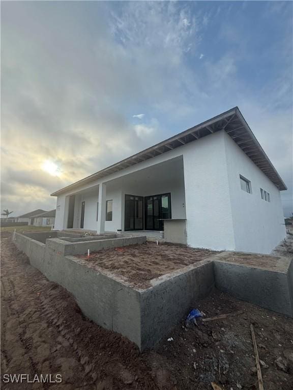 rear view of house with stucco siding