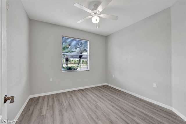 spare room with ceiling fan and light wood-type flooring