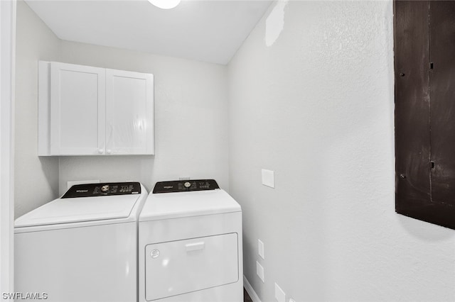 washroom featuring cabinets and washing machine and dryer