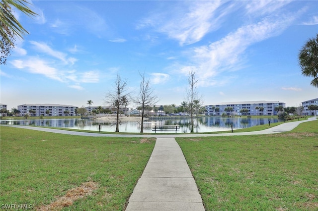 view of property's community featuring a water view and a yard