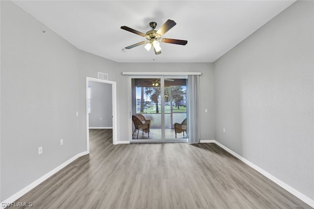 spare room with hardwood / wood-style floors and ceiling fan