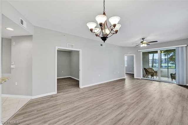 empty room featuring light hardwood / wood-style floors and ceiling fan with notable chandelier