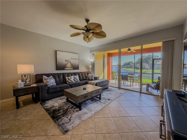 tiled living room featuring a textured ceiling and ceiling fan