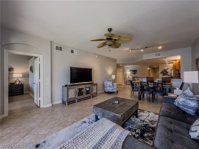 tiled living room featuring ceiling fan