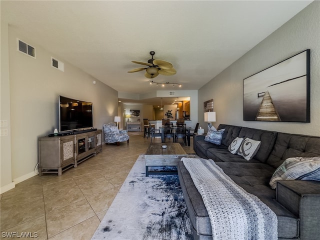 tiled living room featuring ceiling fan