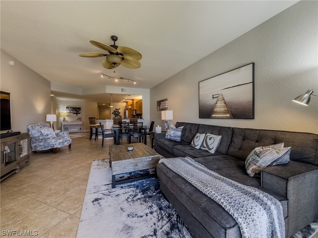 living room with ceiling fan and light tile flooring