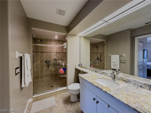 bathroom with vanity, tile floors, a shower with door, and toilet