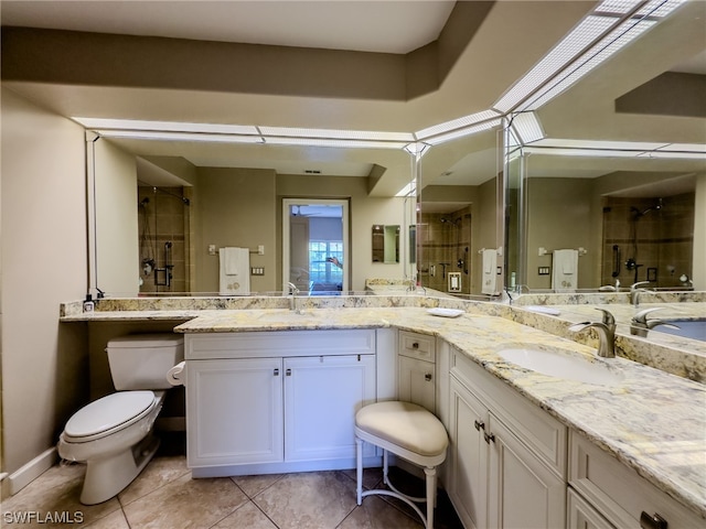 bathroom featuring toilet, tile floors, double sink, and oversized vanity