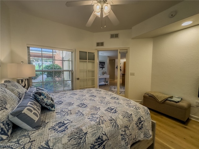 bedroom with light hardwood / wood-style floors and ceiling fan