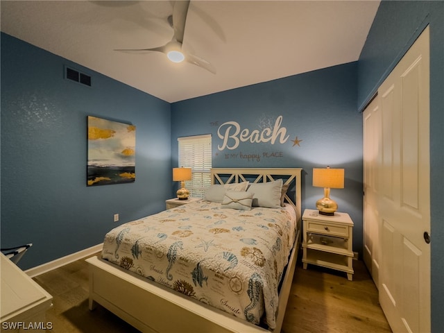 bedroom with a closet, ceiling fan, and dark hardwood / wood-style flooring