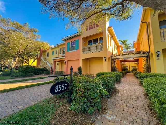 mediterranean / spanish-style house featuring a balcony and a garage