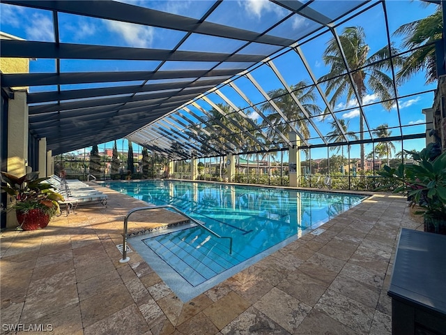 view of swimming pool featuring a patio and a lanai