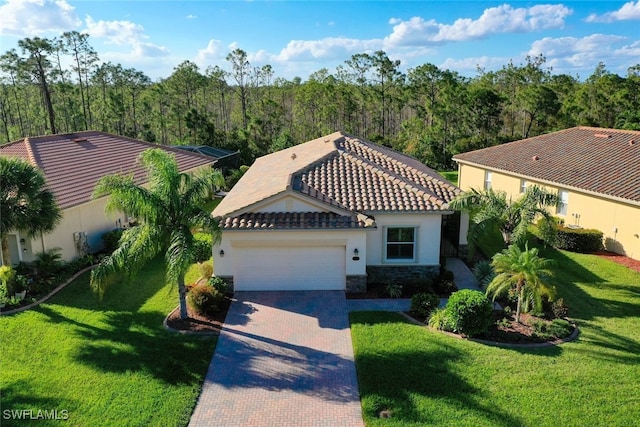 view of front of home featuring a garage and a front lawn