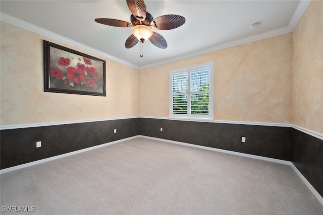 carpeted empty room featuring ceiling fan and ornamental molding