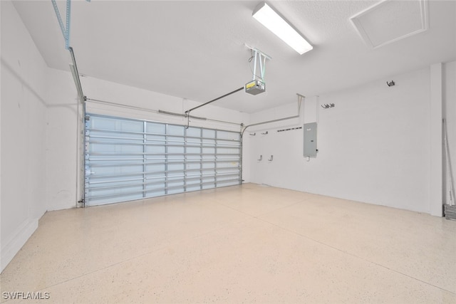 garage with electric panel and a garage door opener