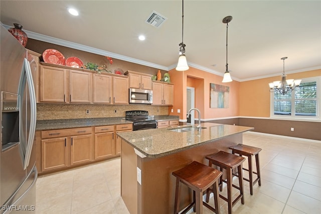 kitchen with a kitchen island with sink, sink, hanging light fixtures, crown molding, and stainless steel appliances