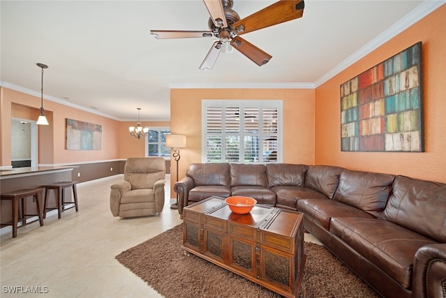 tiled living room with ceiling fan with notable chandelier and ornamental molding