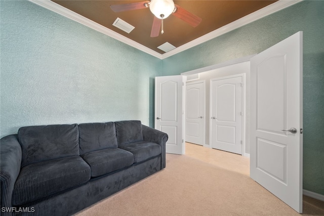 living room with ceiling fan, light colored carpet, and crown molding