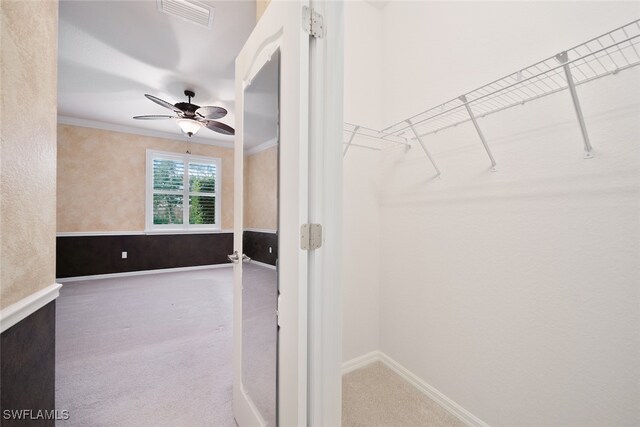 walk in closet with ceiling fan