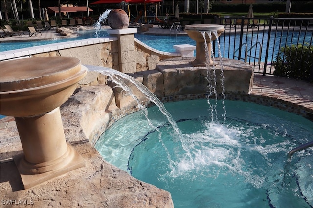 view of pool with pool water feature