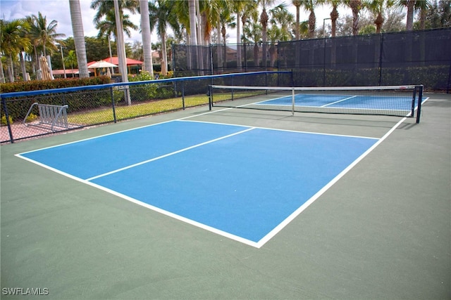 view of tennis court with basketball hoop