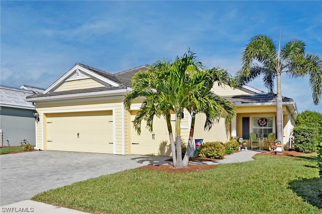 view of front of house featuring a front yard and a garage