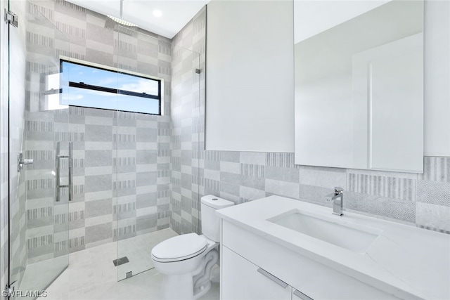 bathroom featuring toilet, oversized vanity, tile walls, backsplash, and an enclosed shower